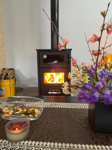 a living room with a stove with a plate of food at ''The Stone'' in Agios Vlasios