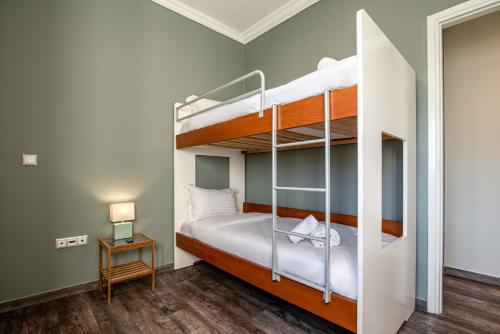 a bedroom with two bunk beds in a room at Athenian Serene City Escape in Athens