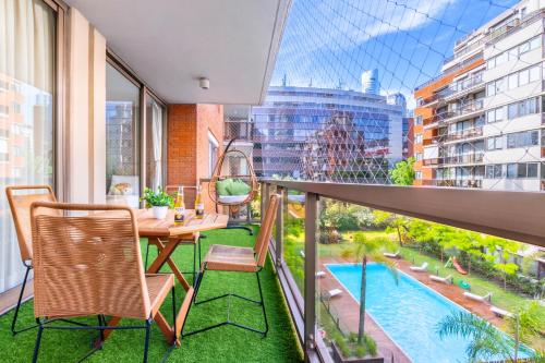 a balcony with a table and chairs and a pool at Luxury Apartments in Puerto Madero in Buenos Aires