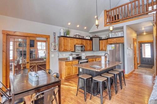 a kitchen with wooden cabinets and a table and chairs at Gold Rush Lodge in Lead