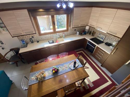 an overhead view of a kitchen with a table and chairs at ''The Stone'' in Agios Vlasios