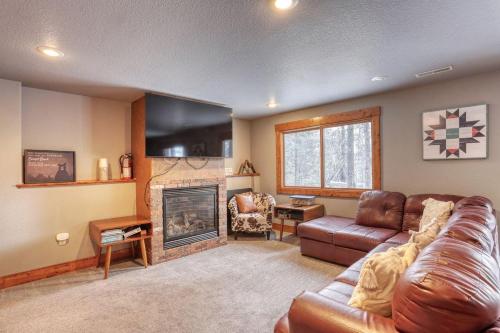 a living room with a couch and a fireplace at Gold Rush Lodge in Lead
