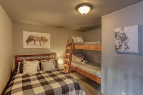 a bedroom with a bunk bed and two bunk beds at Gold Rush Lodge in Lead