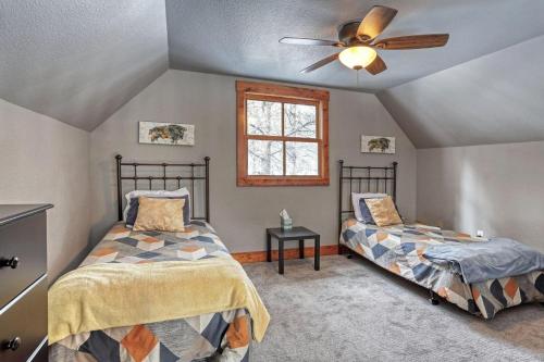 a bedroom with two beds and a ceiling fan at Gold Rush Lodge in Lead