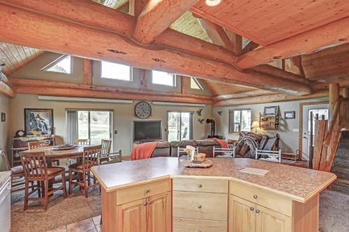 a kitchen and living room with wooden ceilings and a table at Elk Creek Retreat in Lead