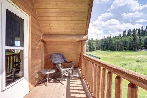 a porch of a cabin with a chair and a table at Elk Creek Retreat in Lead
