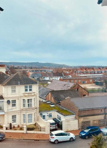 a city with cars parked in a parking lot at East Beach Hotel in Eastbourne