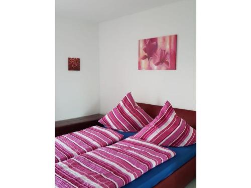 a couch with pink and purple pillows on it at Villa Lake Constance view in Stetten