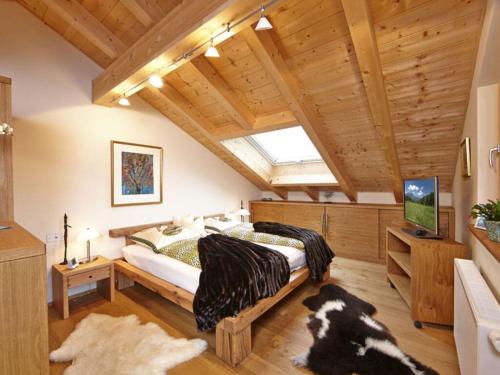 ein Schlafzimmer mit einem großen Bett in einem Zimmer mit Holzdecken in der Unterkunft Holiday apartment Zugspitzblick-Riedel in Garmisch-Partenkirchen