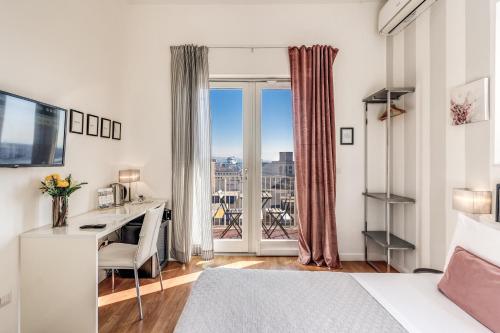 a bedroom with a bed and a desk with a desk at Napoli Great View B&B in Naples