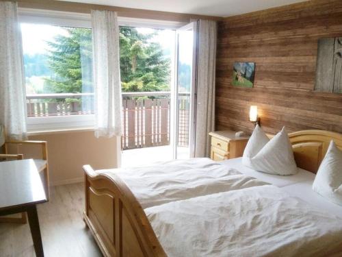 a bedroom with a bed and a large window at Holiday home Eckstein in Oy-Mittelberg