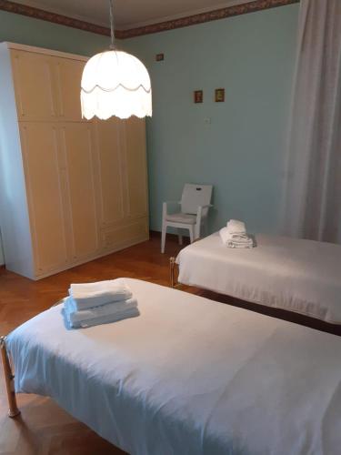 a room with two beds and a chandelier at Gold House in Maranello