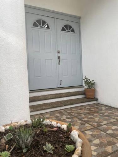 a front door of a house with a garden in front at Casa Maya en el mejor lugar de Puerto Escondido in Puerto Escondido