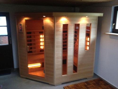 a storage unit with lights in a room at Holiday home Baltic Sea Dream in Zudar