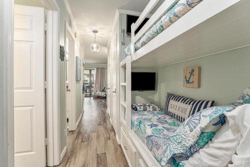 a room with a bed and a tv in it at Casa Del Marlin - Your Beach Retreat on Galveston Island, TX in Galveston