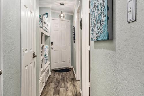 a hallway with a white door and a hallway sidx sidx sidx at Casa Del Marlin - Your Beach Retreat on Galveston Island, TX in Galveston