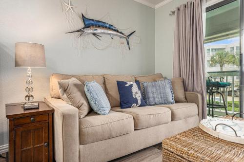 a living room with a couch and a fish on the wall at Casa Del Marlin - Your Beach Retreat on Galveston Island, TX in Galveston