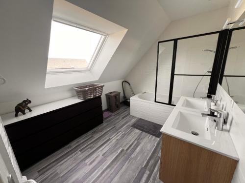 a bathroom with a sink and a toilet and a window at Maison chaleureuse tout confort in Amboise