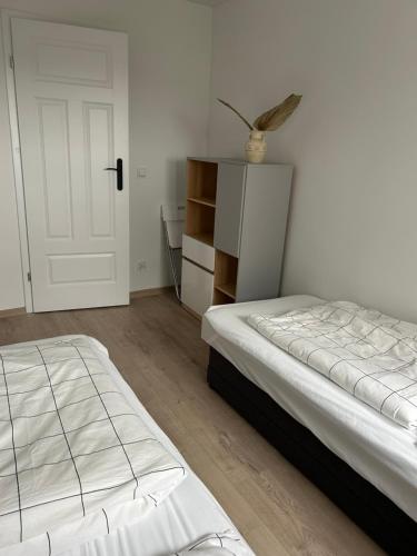 a bedroom with a bed and a white door at Apartament nad Wdą in Świecie