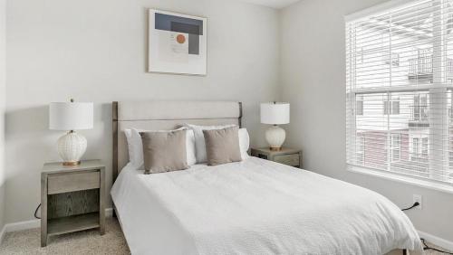 a white bedroom with a white bed and two night stands at Landing - Modern Apartment with Amazing Amenities (ID1218X266) in Dublin