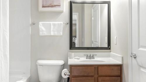 Baño blanco con lavabo y espejo en Landing - Modern Apartment with Amazing Amenities (ID1218X266), en Dublin