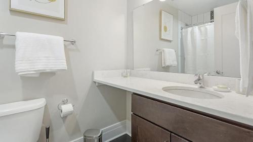 a white bathroom with a sink and a toilet at Landing - Modern Apartment with Amazing Amenities (ID7691X05) in Richmond