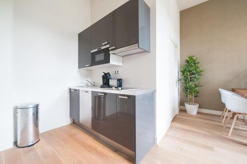 a kitchen with stainless steel appliances in a room at Museumpark Apartments in Rotterdam