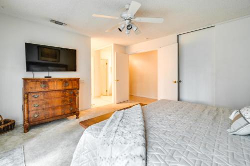 a bedroom with a bed and a flat screen tv at Sun-Kissed Orangevale Home with Private Hot Tub! in Orangevale