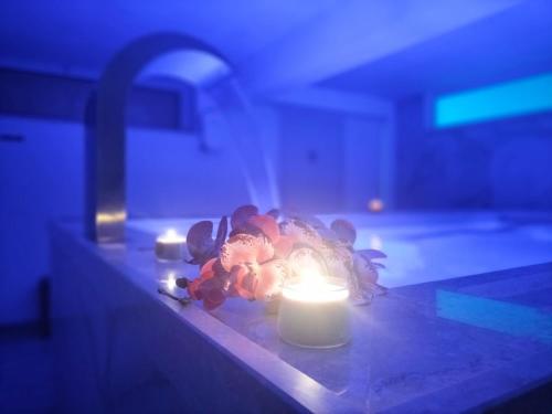 a candle sitting on a counter next to a sink at mya luxury rooms and wellness in Melendugno