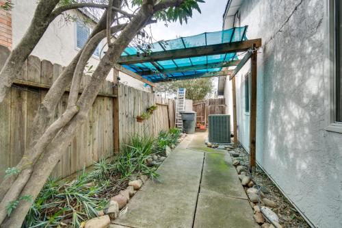 a walkway leading to a fence with a glass roof at Sun-Kissed Orangevale Home with Private Hot Tub! in Orangevale