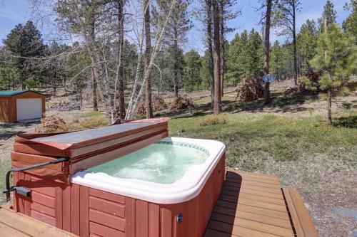 a hot tub on a wooden deck in the woods at Midway Meadows - very Private! in Lead