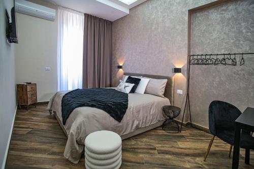 a hotel room with a bed and a desk at Lustru Apartment in Catania
