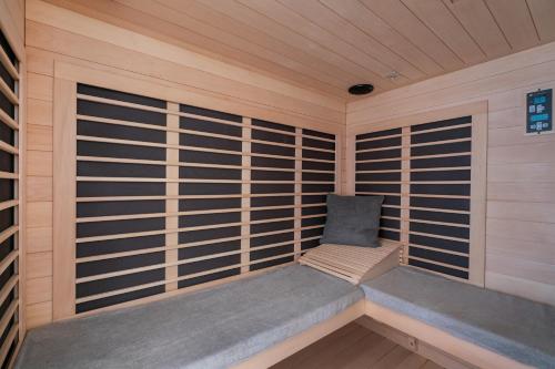 a sauna with a bench in a wooden cabin at Lake and Vineyard Views Country Home with Spa! in Warren