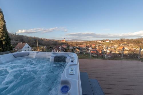 a hot tub on the roof of a house at Lila akác vendégház in Keszü