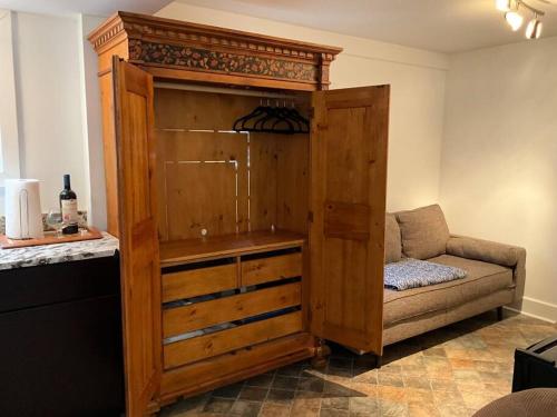 a large wooden cabinet with a couch in a room at Charming Studio in the Heart of Springfield in Jacksonville