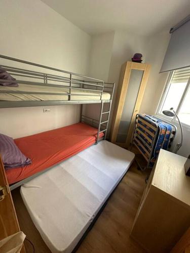 a small room with two bunk beds and a window at Casa Del Mar in Águilas