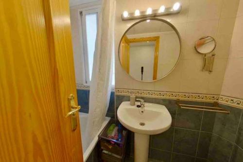 a bathroom with a sink and a mirror at Casa Del Mar in Águilas