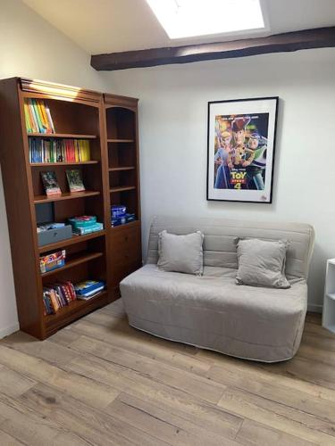 a room with a bed and a book shelf at Maison toute équipée Gerzat in Gerzat