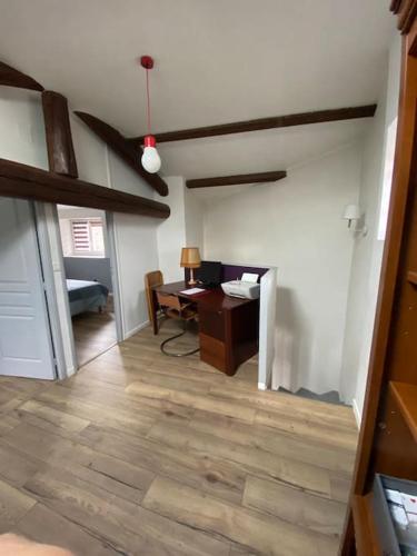 a living room with a desk and a ceiling fan at Maison toute équipée Gerzat in Gerzat