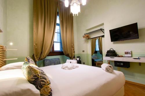 a bedroom with a bed with towels on it at N4U Guest House Florence in Florence