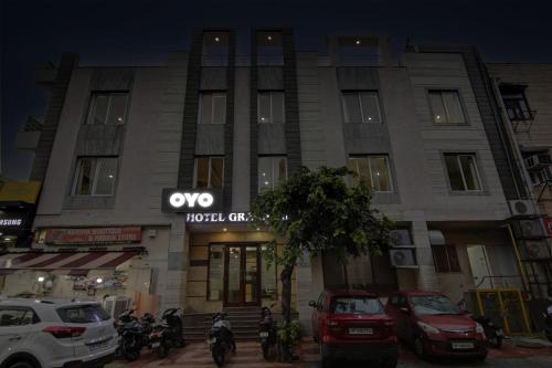 a building with cars parked in front of it at Townhouse Grand Inn in Ghaziabad