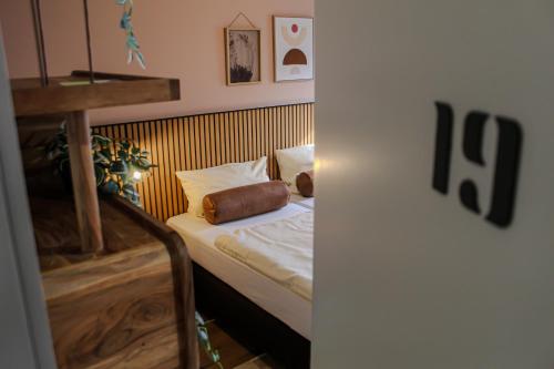 een kleine slaapkamer met een bed met witte lakens bij Airport Hotel Jägerhof Weeze in Weeze