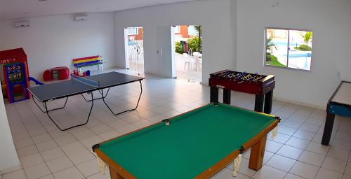 a room with two tables and a pool table at LAGOA QUENTE FLATS in Caldas Novas