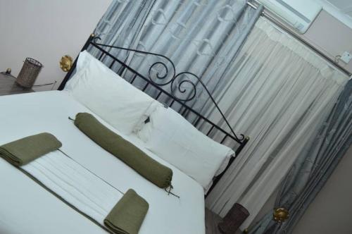 a bed with a metal head board and pillows at MOGONONO SELECTED SERVICE HOTEL in Palatswe