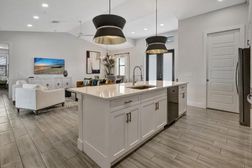 a kitchen with white cabinets and a kitchen island at Luxury Retreat in Secret Paradise in Bonita Springs
