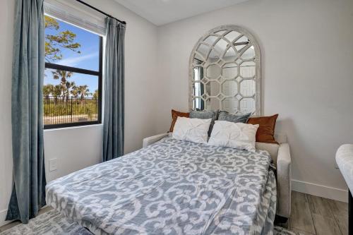 a bedroom with a bed with a large window at Luxury Retreat in Secret Paradise in Bonita Springs
