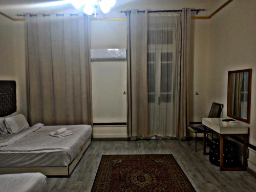 a hotel room with a bed and a desk and a window at Trafiko in Cairo