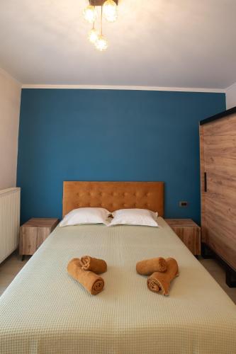 a bedroom with a bed with two towels on it at ELEGANCE SUITES in Plataria