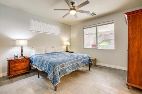 a bedroom with a bed and a ceiling fan at Desert Escape with Pool Oasis Near Golfing and Vegas! in Las Vegas