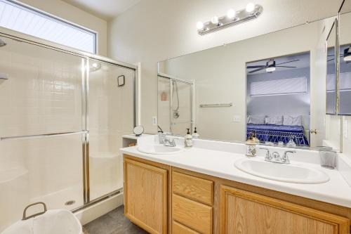 a bathroom with two sinks and a shower at Desert Escape with Pool Oasis Near Golfing and Vegas! in Las Vegas